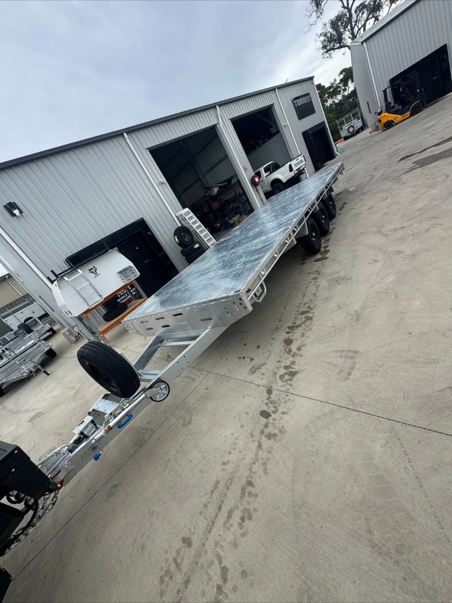 Galvanised tandem flat top trailer outside the workshop