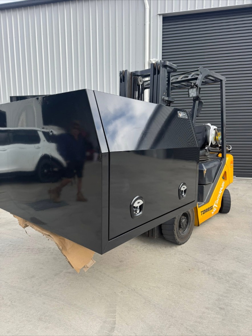 Powdercoated gloss black steel and aluminium toolbox on a forklift